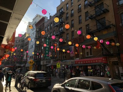 Colorful paper lanterns strung above a street in New York City's Chinatown